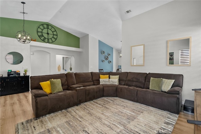 13797 Mesquite Dr, Fontana, CA 92337 - living area with high vaulted ceiling, wood finished floors, and a chandelier