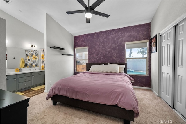 13797 Mesquite Dr, Fontana, CA 92337 - bedroom with multiple windows, a closet, ensuite bathroom, light colored carpet, and lofted ceiling