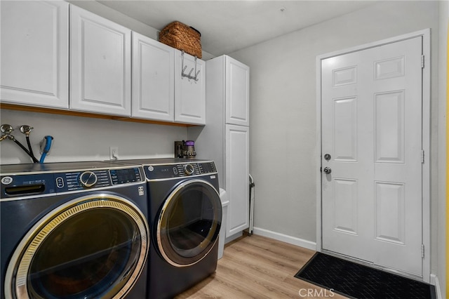 13797 Mesquite Dr, Fontana, CA 92337 - washroom featuring cabinet space, washer and clothes dryer, light wood-style flooring, and baseboards