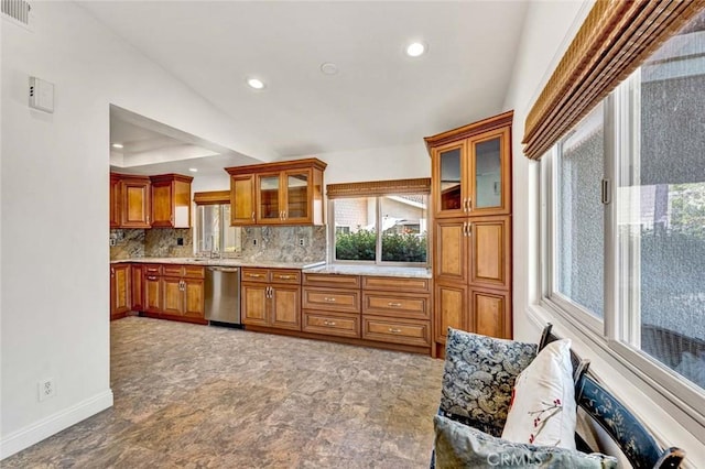 8815 Yuba Cir Unit 1102A, Huntington Beach, CA 92646 - kitchen with stainless steel dishwasher, brown cabinets, baseboards, recessed lighting, and backsplash