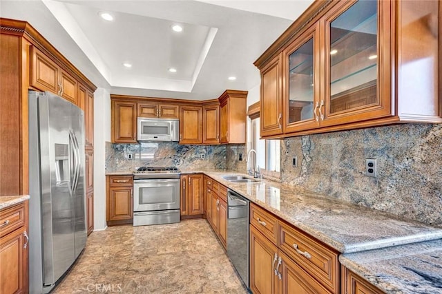 8815 Yuba Cir Unit 1102A, Huntington Beach, CA 92646 - kitchen featuring appliances with stainless steel finishes, a sink, brown cabinets, light stone counters, and recessed lighting