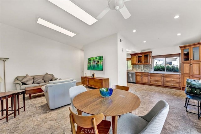 8815 Yuba Cir Unit 1102A, Huntington Beach, CA 92646 - dining area featuring vaulted ceiling, ceiling fan, a skylight, and recessed lighting