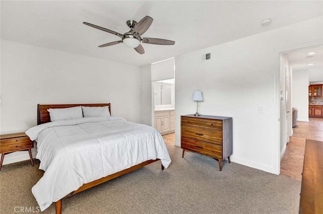8815 Yuba Cir Unit 1102A, Huntington Beach, CA 92646 - bedroom featuring light carpet, baseboards, ensuite bath, and a ceiling fan