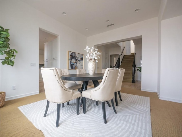 8365 Sanctuary Dr, Corona, CA 92883 - dining space with stairway, light colored carpet, and baseboards