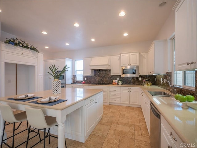 8365 Sanctuary Dr, Corona, CA 92883 - kitchen with a sink, stainless steel appliances, custom range hood, decorative backsplash, and white cabinetry