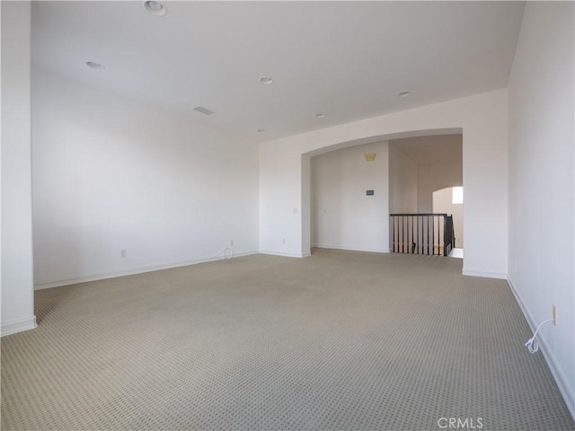 8365 Sanctuary Dr, Corona, CA 92883 - unfurnished room featuring light carpet, arched walkways, and baseboards