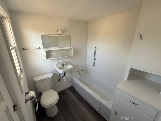3874 Kreuer Rd, Phelan, CA 92371 - bathroom with toilet, wood finished floors, a sink, and washtub / shower combination