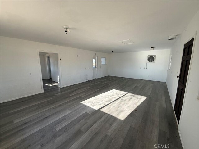 3874 Kreuer Rd, Phelan, CA 92371 - unfurnished living room featuring dark wood-type flooring and baseboards