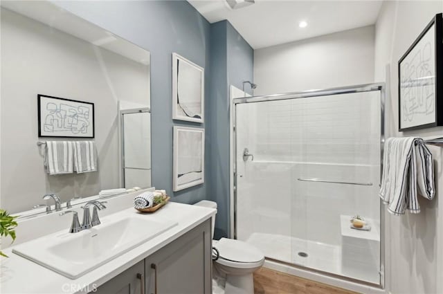 41847 Oak Barrel Ct, Palmdale, CA 93551 - full bathroom with toilet, a stall shower, vanity, recessed lighting, and wood finished floors