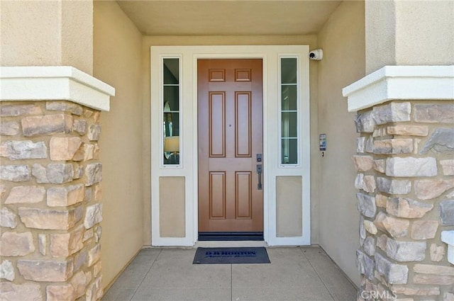 41847 Oak Barrel Ct, Palmdale, CA 93551 - property entrance featuring stucco siding, stone siding, and a surveillance system