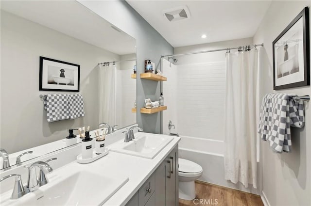 41847 Oak Barrel Ct, Palmdale, CA 93551 - bathroom with toilet, wood finished floors, shower / bath combination with curtain, double vanity, and recessed lighting