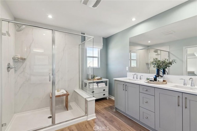 41847 Oak Barrel Ct, Palmdale, CA 93551 - full bath with double vanity, a marble finish shower, wood finished floors, and recessed lighting