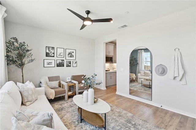 41847 Oak Barrel Ct, Palmdale, CA 93551 - living area with ceiling fan, light wood-style flooring, arched walkways, and baseboards