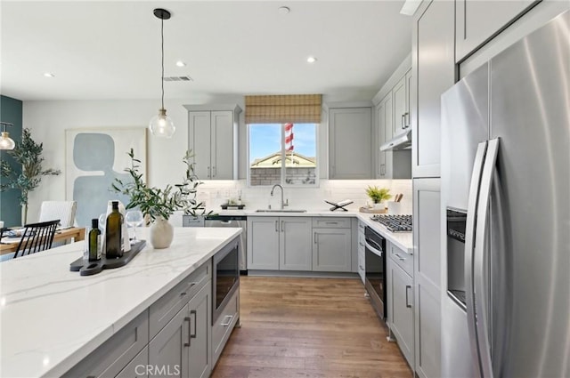 41847 Oak Barrel Ct, Palmdale, CA 93551 - kitchen featuring appliances with stainless steel finishes, gray cabinets, a sink, decorative backsplash, and recessed lighting