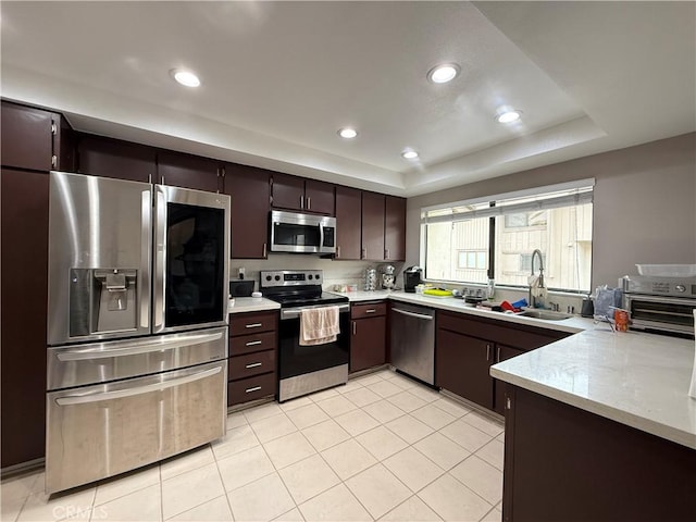 6310 Ridgemar Ct, Rancho Palos Verdes, CA 90275 - kitchen featuring stainless steel appliances, a sink, a tray ceiling, dark brown cabinets, and recessed lighting