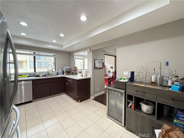 6310 Ridgemar Ct, Rancho Palos Verdes, CA 90275 - kitchen featuring appliances with stainless steel finishes, dark brown cabinets, beverage cooler, light countertops, and recessed lighting