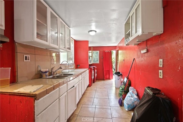 213 N Figueroa St, Santa Ana, CA 92703 - kitchen with a sink, washer / dryer, white cabinets, glass insert cabinets, and light tile patterned floors