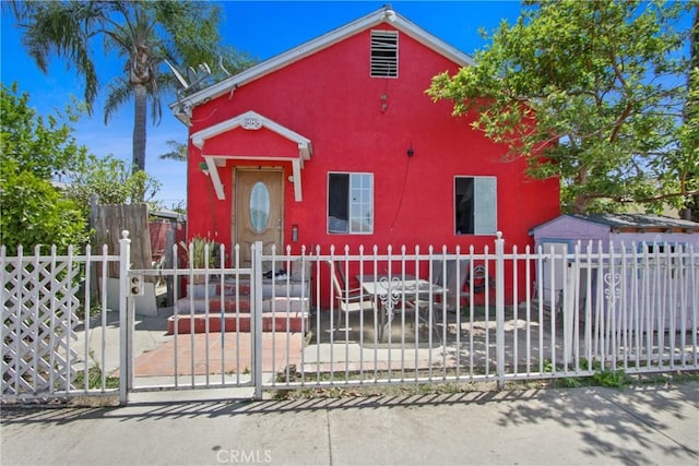 213 N Figueroa St, Santa Ana, CA 92703 - view of front of property featuring stucco siding, a fenced front yard, and a gate