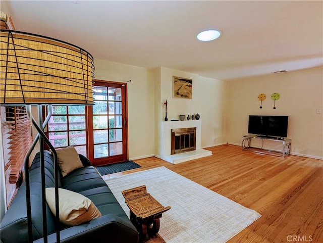 15123 Killion St, Sherman Oaks, CA 91411 - living area featuring wood finished floors, a glass covered fireplace, and baseboards
