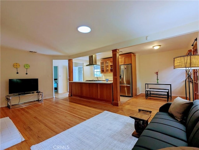 15123 Killion St, Sherman Oaks, CA 91411 - living room featuring ornate columns, light wood-type flooring, and baseboards