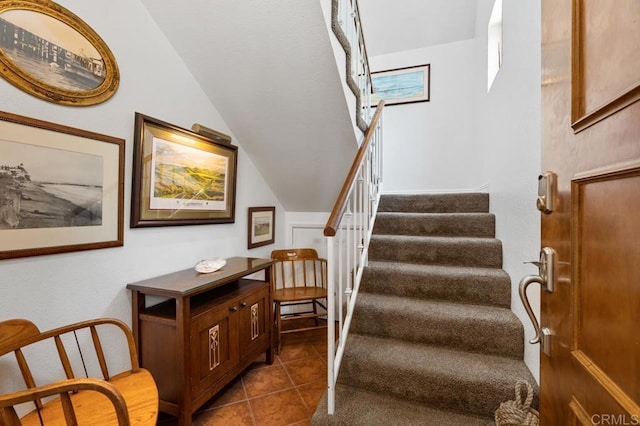 374 Orange Ave Unit F, Coronado, CA 92118 - staircase featuring tile patterned flooring and vaulted ceiling