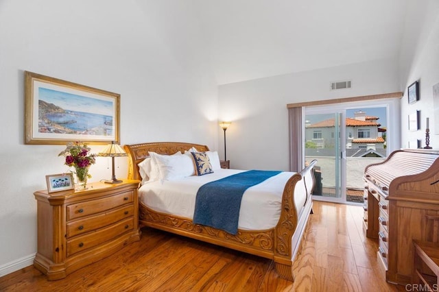 374 Orange Ave Unit F, Coronado, CA 92118 - bedroom with hardwood / wood-style flooring, access to outside, vaulted ceiling, and baseboards