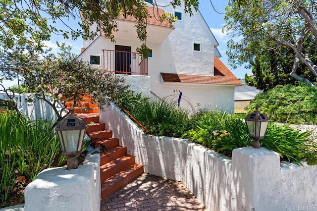 374 Orange Ave Unit F, Coronado, CA 92118 - view of front facade featuring stucco siding and stairway