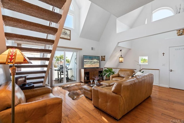 374 Orange Ave Unit F, Coronado, CA 92118 - living area featuring a high ceiling, healthy amount of natural light, hardwood / wood-style floors, and stairs
