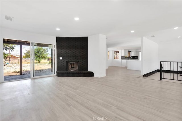 14855 Flathead Rd, Apple Valley, CA 92307 - unfurnished living room featuring light wood-type flooring, recessed lighting, and a fireplace