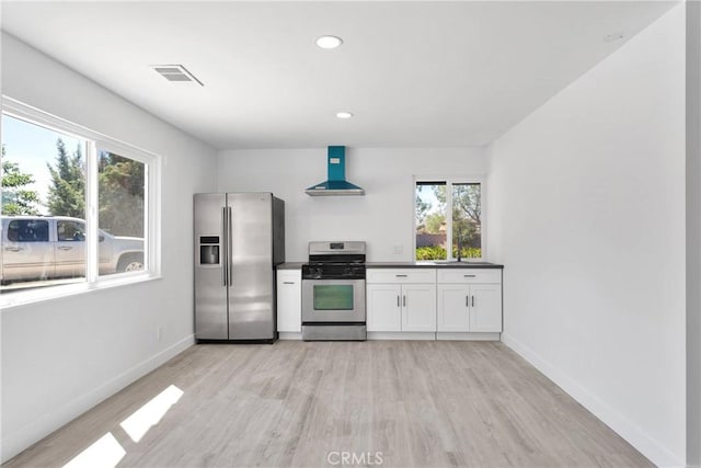 14855 Flathead Rd, Apple Valley, CA 92307 - kitchen featuring appliances with stainless steel finishes, wall chimney range hood, light wood-style flooring, dark countertops, and recessed lighting