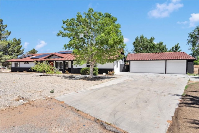 14855 Flathead Rd, Apple Valley, CA 92307 - view of front facade featuring a tiled roof, roof mounted solar panels, and driveway