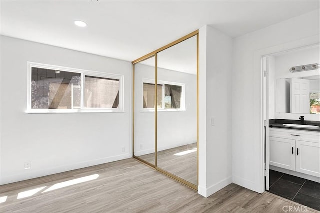 14855 Flathead Rd, Apple Valley, CA 92307 - unfurnished bedroom featuring a sink, wood finished floors, a closet, baseboards, and recessed lighting