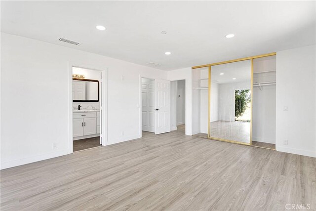 14855 Flathead Rd, Apple Valley, CA 92307 - unfurnished bedroom with light wood-style flooring, recessed lighting, baseboards, and ensuite bathroom