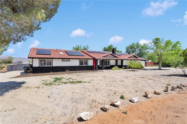 14855 Flathead Rd, Apple Valley, CA 92307 - view of front facade with roof mounted solar panels, a tile roof, and a chimney