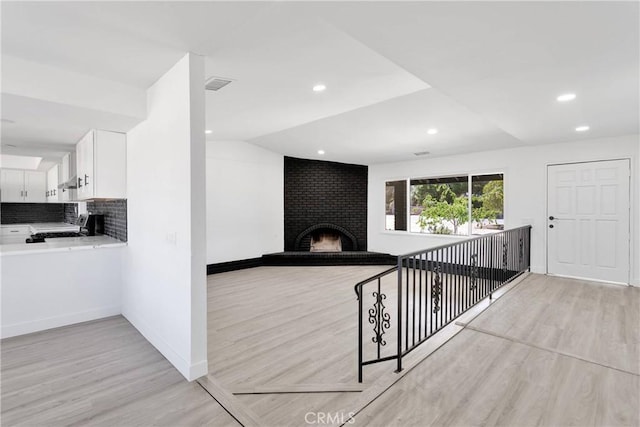 14855 Flathead Rd, Apple Valley, CA 92307 - hallway with light wood finished floors, baseboards, vaulted ceiling, and recessed lighting