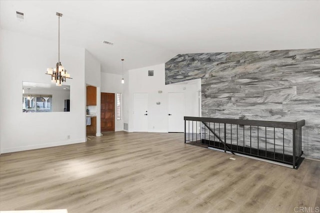 1435 Archwood Pl, Escondido, CA 92026 - living room with a chandelier, wood finished floors, high vaulted ceiling, baseboards, and an accent wall