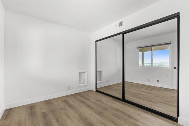 1435 Archwood Pl, Escondido, CA 92026 - unfurnished bedroom with wood finished floors, baseboards, and a closet