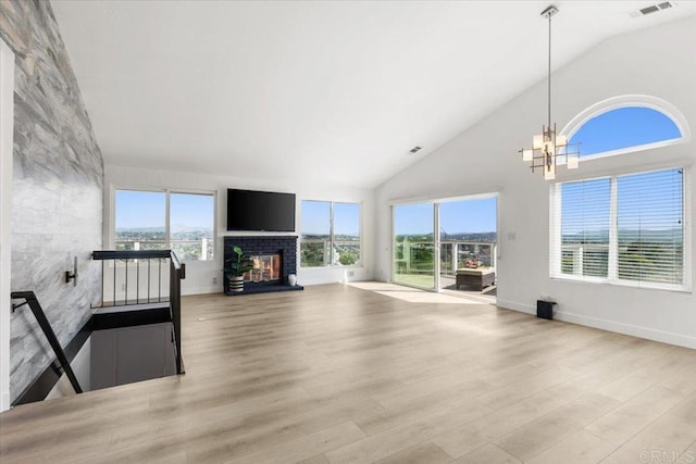 1435 Archwood Pl, Escondido, CA 92026 - unfurnished living room with high vaulted ceiling, wood finished floors, a glass covered fireplace, a chandelier, and baseboards