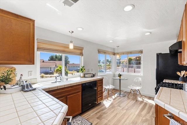 1435 Archwood Pl, Escondido, CA 92026 - kitchen with black appliances, tile countertops, light wood finished floors, exhaust hood, and recessed lighting