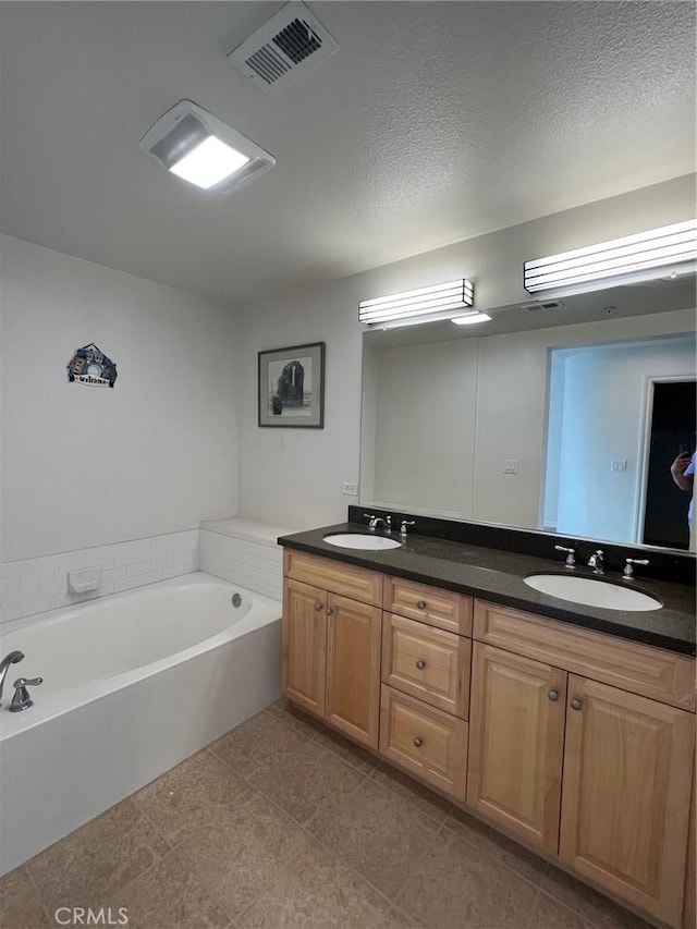 78 E Bay State St Unit 1E, Alhambra, CA 91801 - full bath with double vanity, a bath, tile patterned flooring, and a textured ceiling