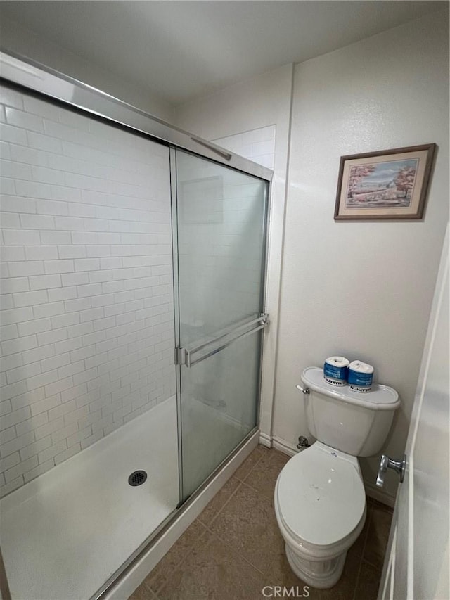 78 E Bay State St Unit 1E, Alhambra, CA 91801 - bathroom featuring toilet, a stall shower, tile patterned floors, and baseboards