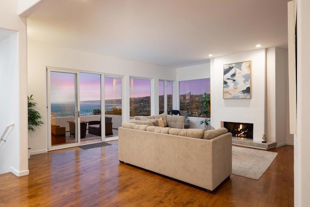 7784 Lookout Dr, La Jolla, CA 92037 - living area with a lit fireplace, recessed lighting, wood finished floors, and baseboards