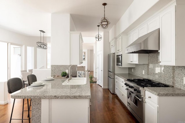 7784 Lookout Dr, La Jolla, CA 92037 - kitchen with ventilation hood, stainless steel appliances, a sink, a breakfast bar area, and dark wood-type flooring