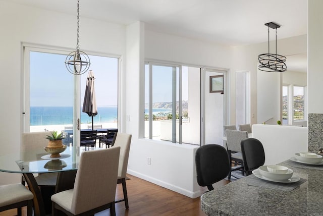 7784 Lookout Dr, La Jolla, CA 92037 - dining space with a chandelier, dark wood finished floors, plenty of natural light, and baseboards