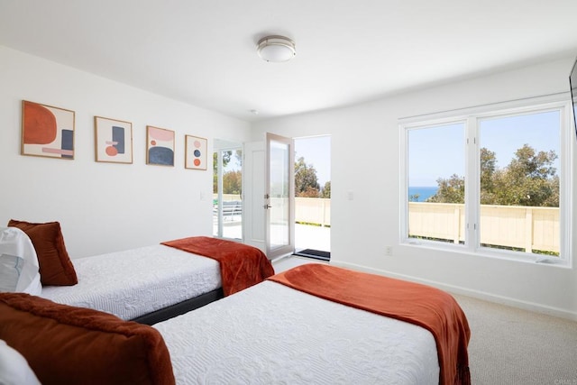7784 Lookout Dr, La Jolla, CA 92037 - carpeted bedroom with access to exterior and baseboards