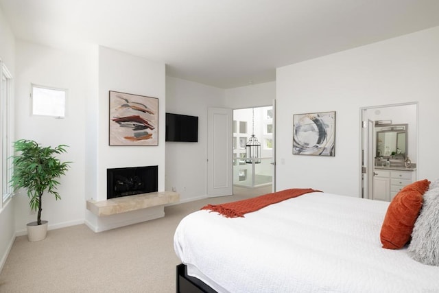 7784 Lookout Dr, La Jolla, CA 92037 - bedroom with light carpet, a fireplace with raised hearth, ensuite bath, baseboards, and multiple windows