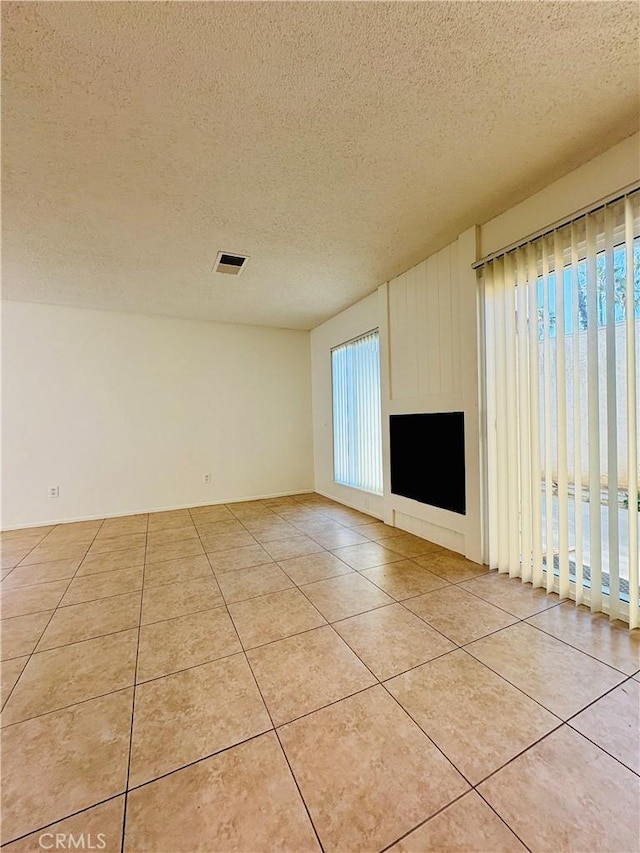 17081 Green Ln, Huntington Beach, CA 92649 - unfurnished living room with a textured ceiling and light tile patterned flooring