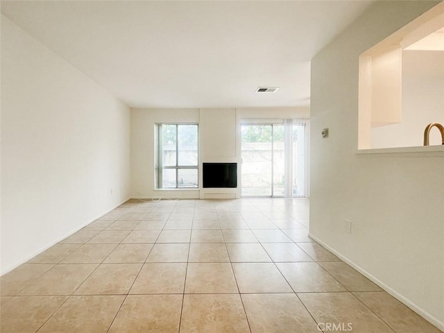 17081 Green Ln, Huntington Beach, CA 92649 - unfurnished living room featuring light tile patterned floors and baseboards