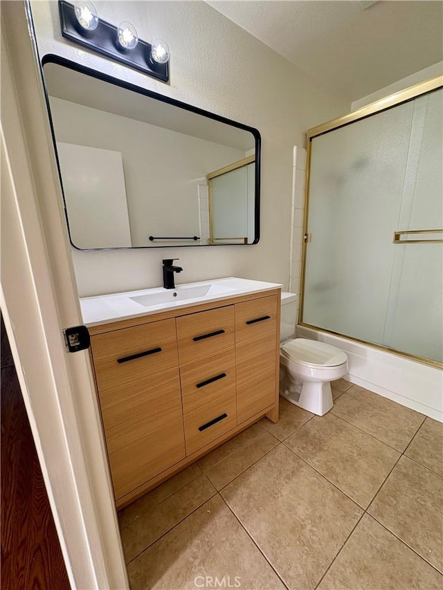 17081 Green Ln, Huntington Beach, CA 92649 - full bathroom with vanity, toilet, combined bath / shower with glass door, and tile patterned flooring