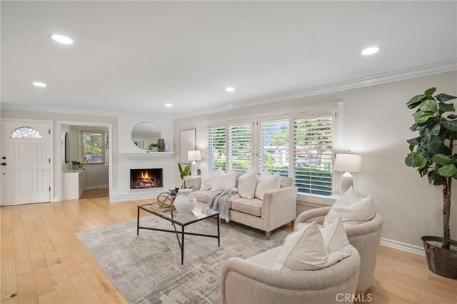 13782 Gershon Pl, North Tustin, CA 92705 - living area featuring light wood-type flooring, plenty of natural light, ornamental molding, a brick fireplace, and recessed lighting